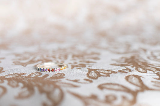 Handmade pave ring with gemstones creating a gradient to create the colors of sunset