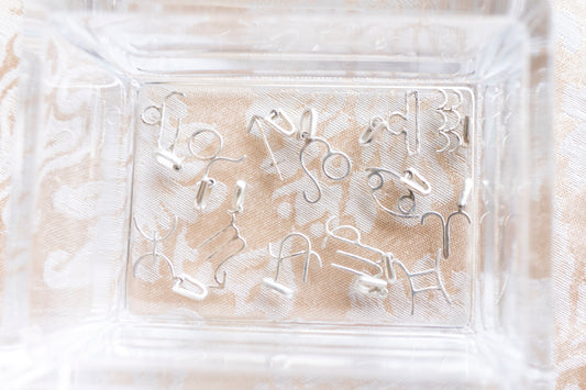 A collection of handmade sterling silver zodiac pendants