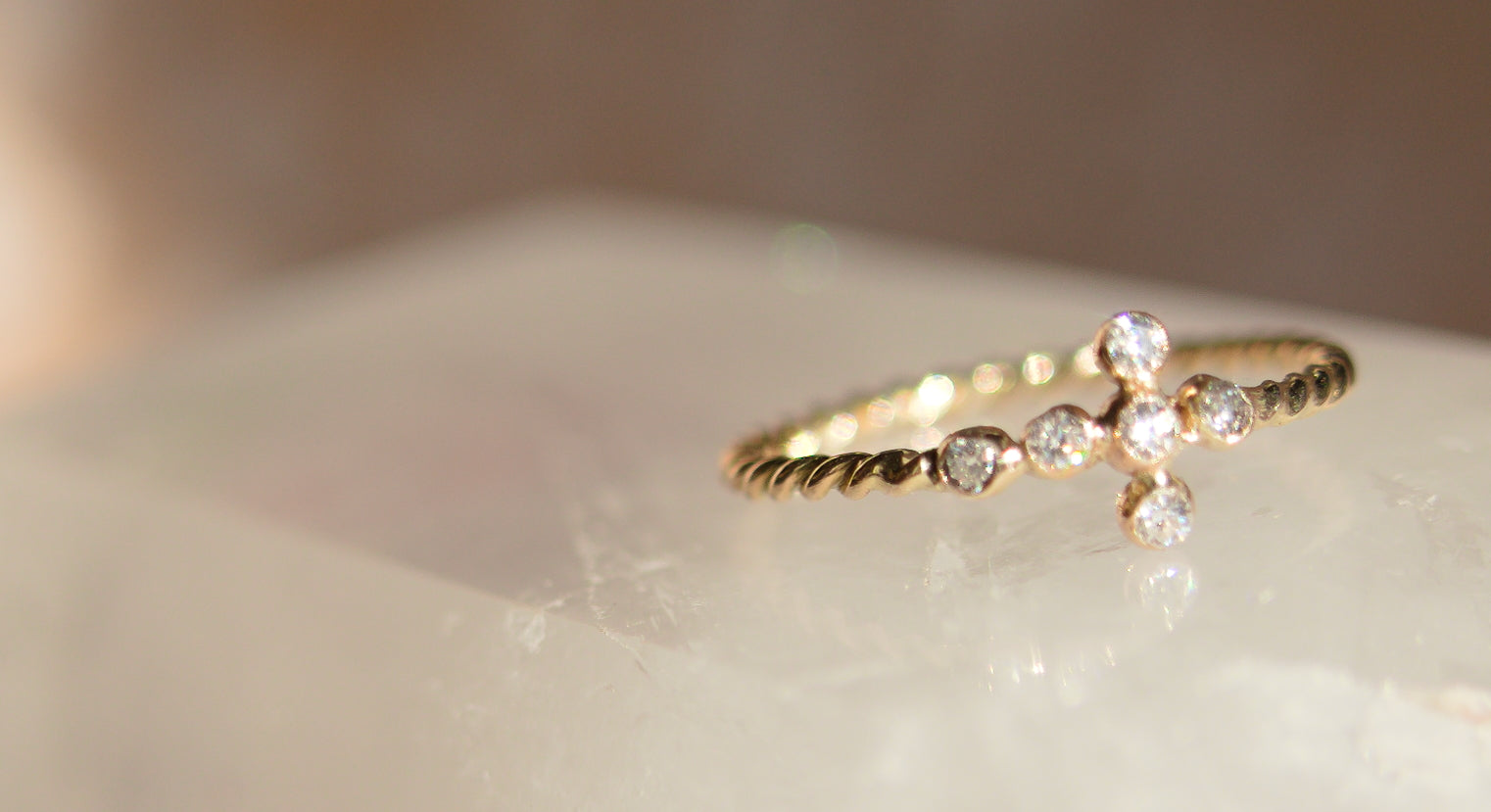 Gold ring with small diamonds on a light background
