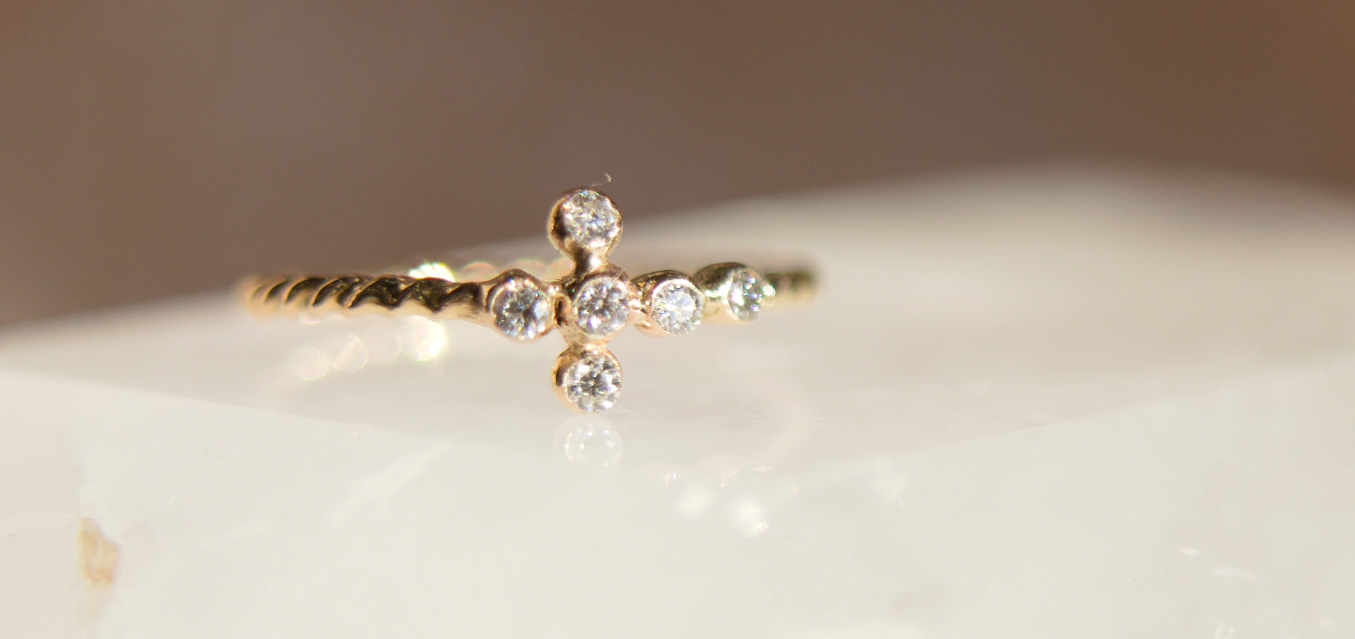 Gold ring with small diamonds on a light background